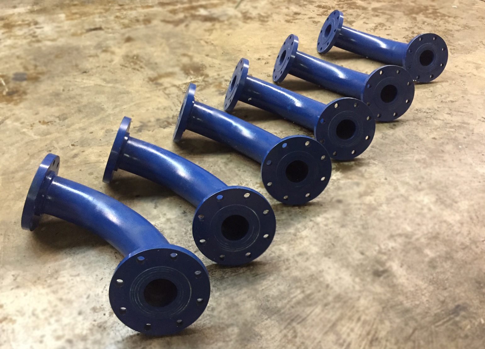 Lineup of blue ceramic lined elbows