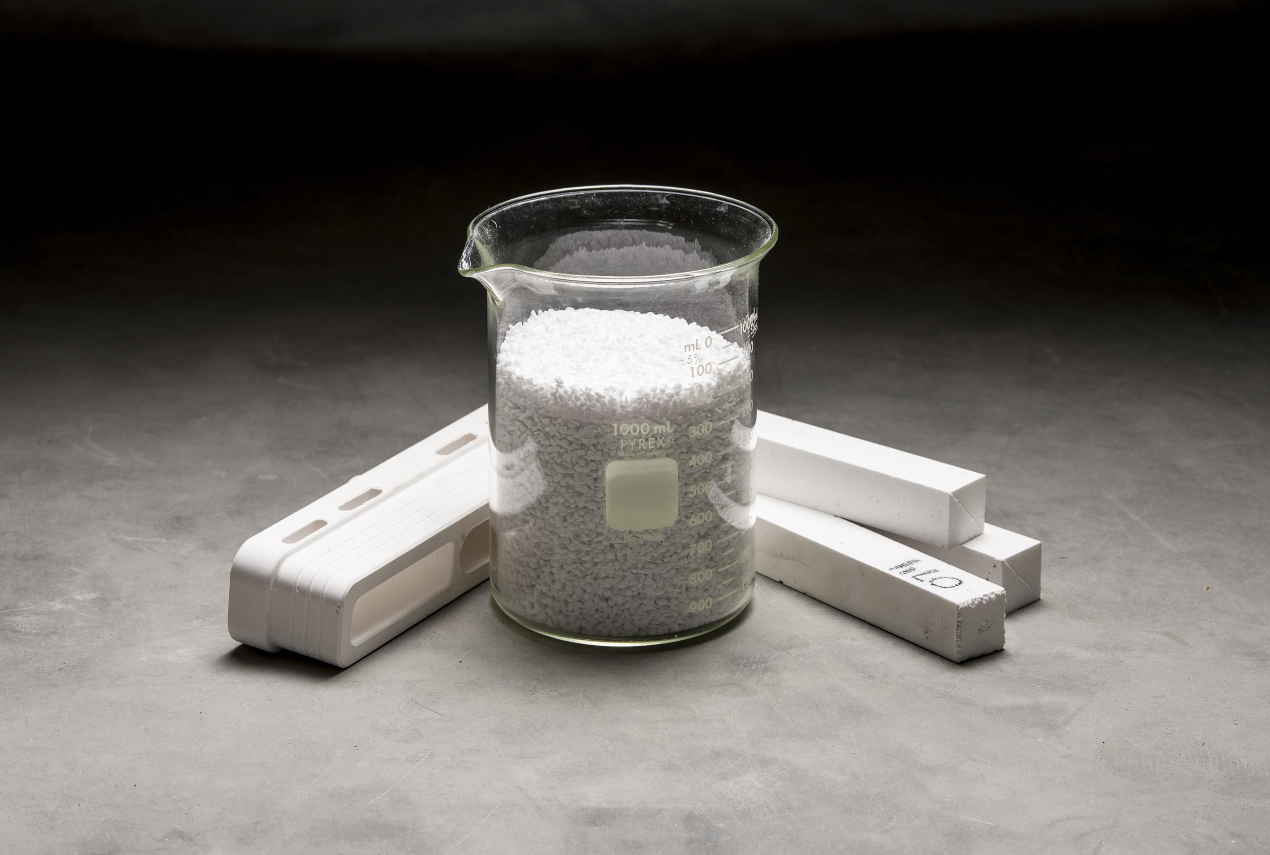 Calcium Silicate product photography - material is in a glass beaker and in various other forms around the beaker